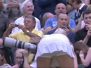 Sweaty tennis young woman bending over after match